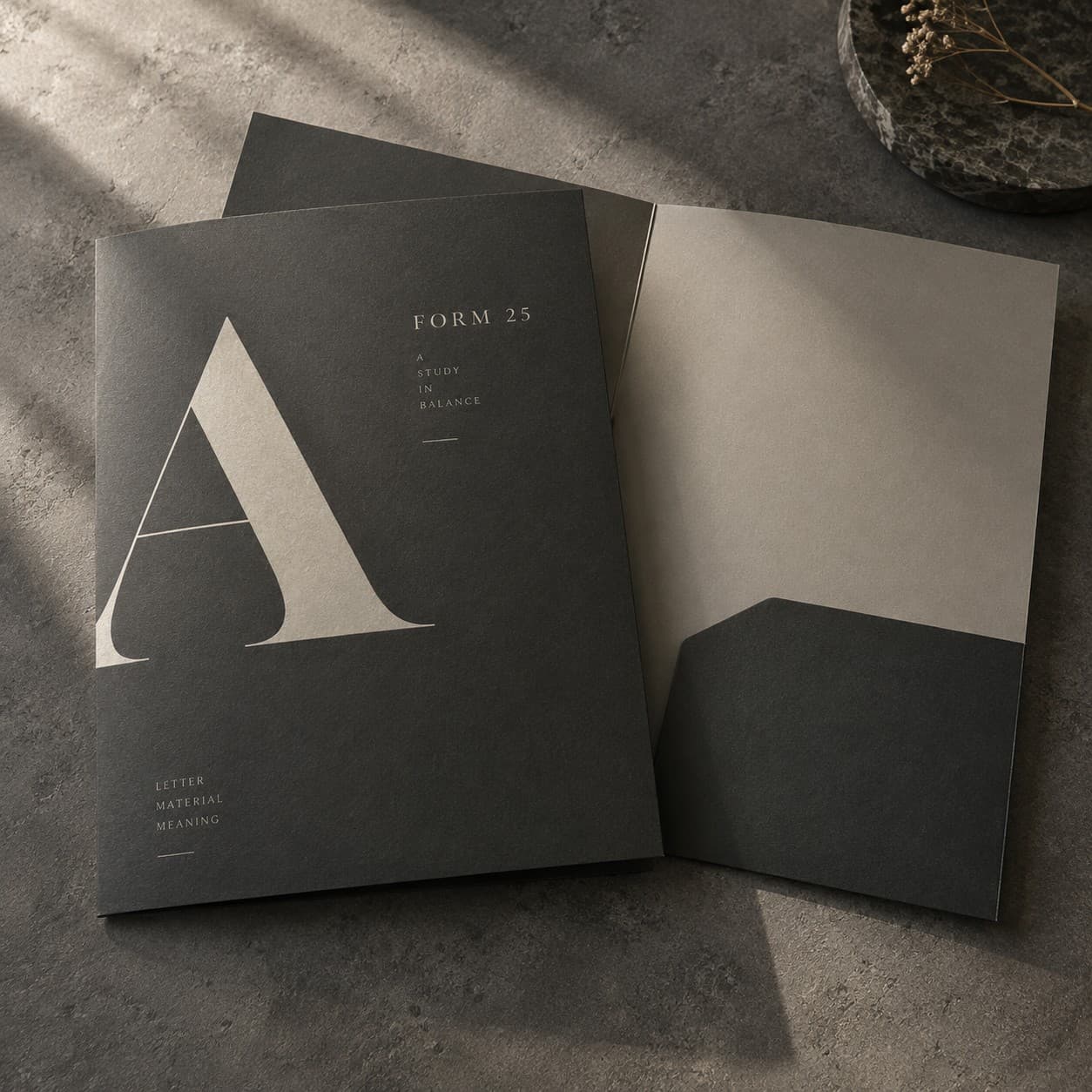 Presentation Folders — charcoal typographic specimen with large letter A
